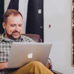 An educator at home on their computer