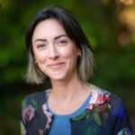 A portrait of Katie Lee Bunting to a blurred, forested background