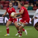 Rachel passes the ball to a teammate on Team Canada as an opposing defensive player approaches
